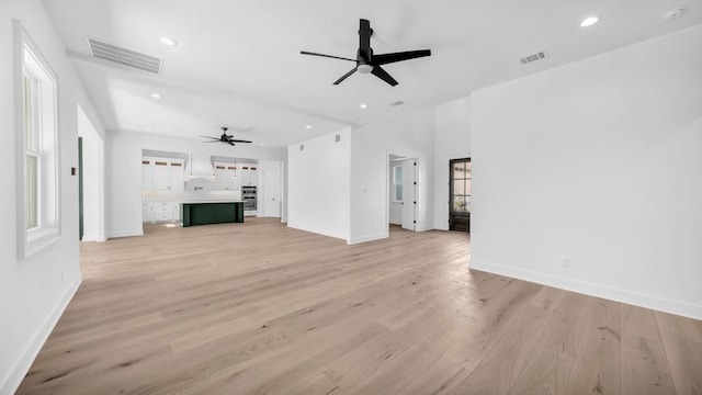 unfurnished living room with visible vents, recessed lighting, baseboards, and light wood-style floors