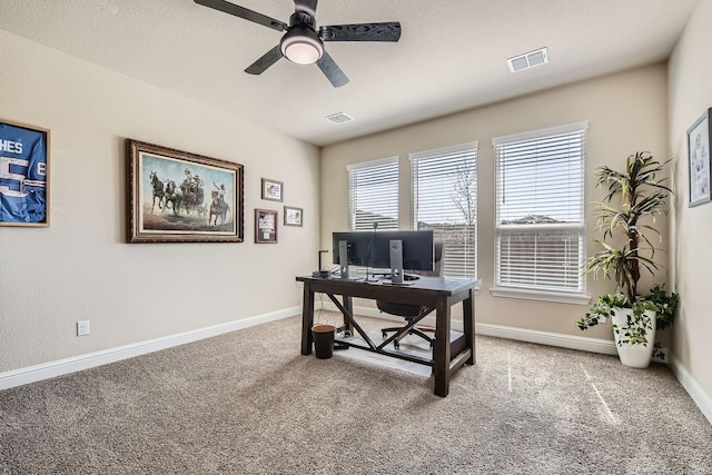 office with visible vents, baseboards, and carpet flooring