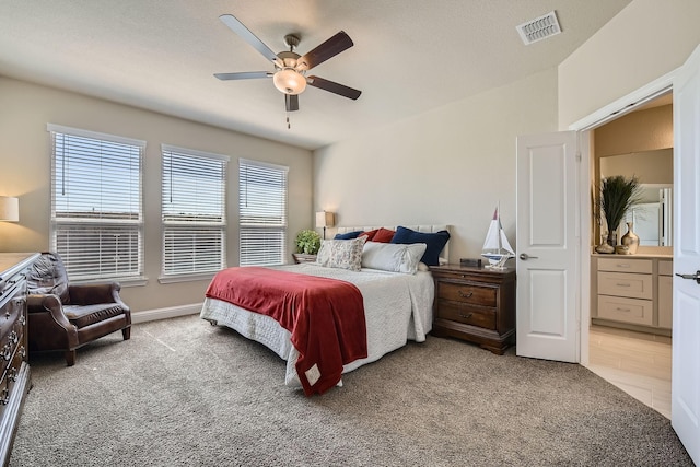 bedroom with light carpet, visible vents, and a ceiling fan