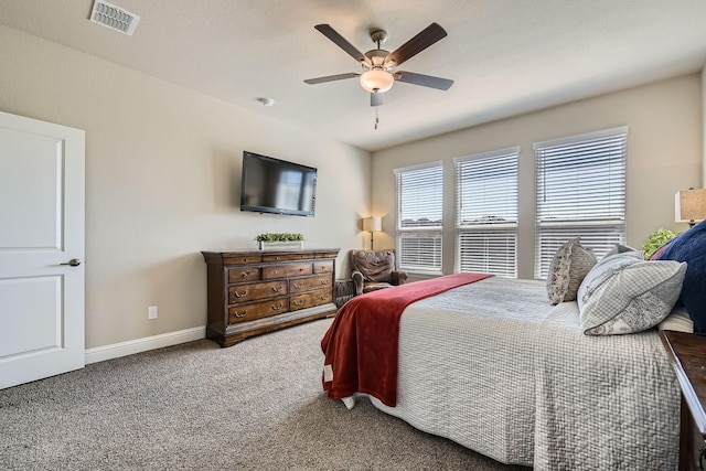 bedroom with visible vents, baseboards, carpet, and a ceiling fan