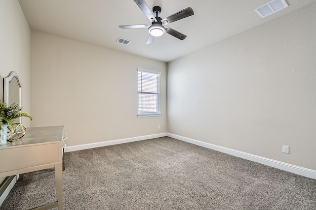 unfurnished office with a ceiling fan, baseboards, visible vents, and carpet floors