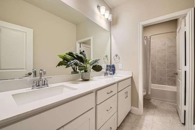 full bathroom featuring double vanity, toilet, shower / bath combo with shower curtain, and a sink