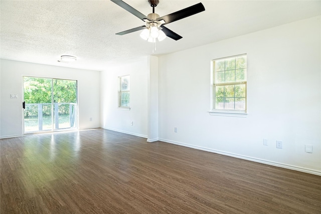 spare room featuring ceiling fan, dark wood-type flooring, baseboards, and a textured ceiling