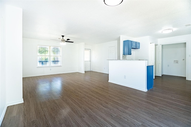 unfurnished living room with baseboards, ceiling fan, and dark wood-style flooring