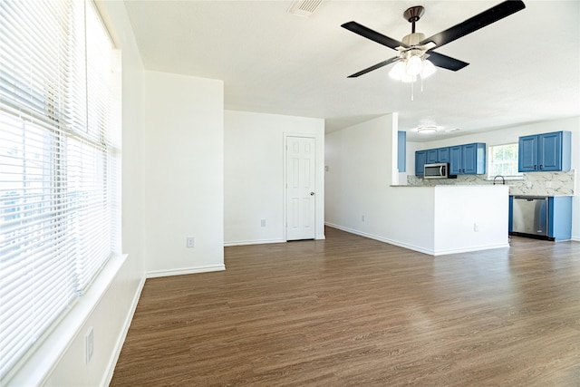 unfurnished living room with visible vents, baseboards, dark wood finished floors, and a ceiling fan