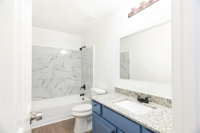 full bathroom with vanity, toilet, wood finished floors, and shower / bathtub combination