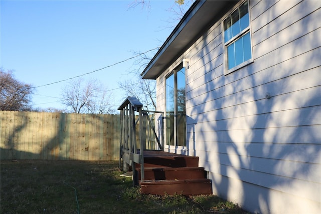 view of side of property featuring fence