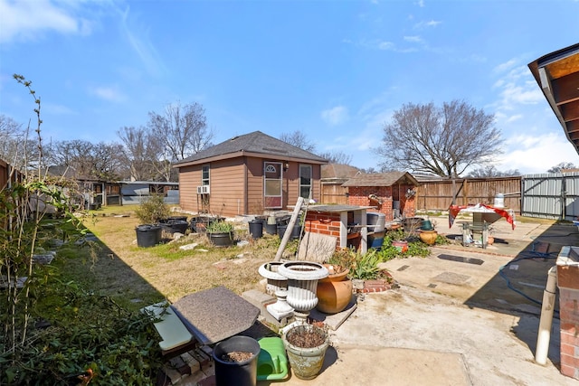 back of house with a patio area, an outdoor structure, and a fenced backyard