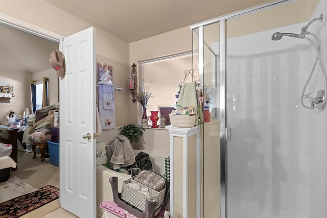 ensuite bathroom featuring ensuite bath and a stall shower