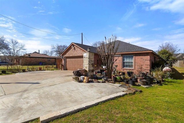 view of front facade featuring driveway, a front lawn, fence, a shingled roof, and brick siding