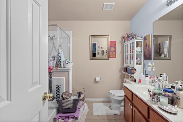 full bathroom featuring tile patterned floors, visible vents, toilet, a shower stall, and vanity