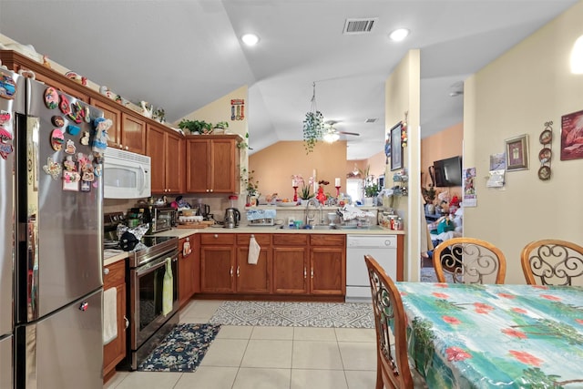 kitchen with visible vents, light countertops, lofted ceiling, stainless steel appliances, and a sink