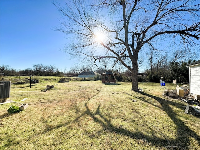 view of yard featuring a playground and central AC