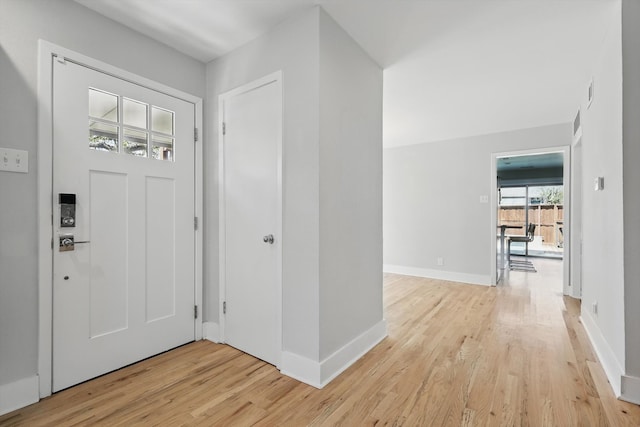 entryway featuring baseboards and light wood-style floors