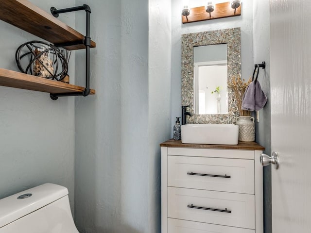 half bathroom with toilet and vanity