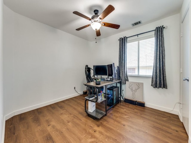 office space featuring visible vents, baseboards, and wood finished floors