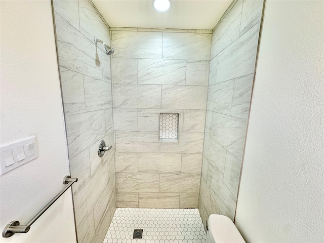 full bathroom with a shower stall and toilet