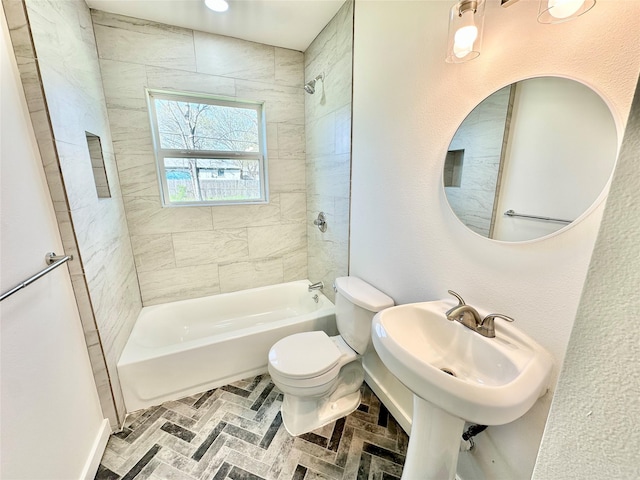 full bathroom featuring brick floor, a sink, shower / tub combination, and toilet