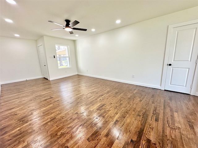 unfurnished room with baseboards, a ceiling fan, dark wood-style floors, and recessed lighting