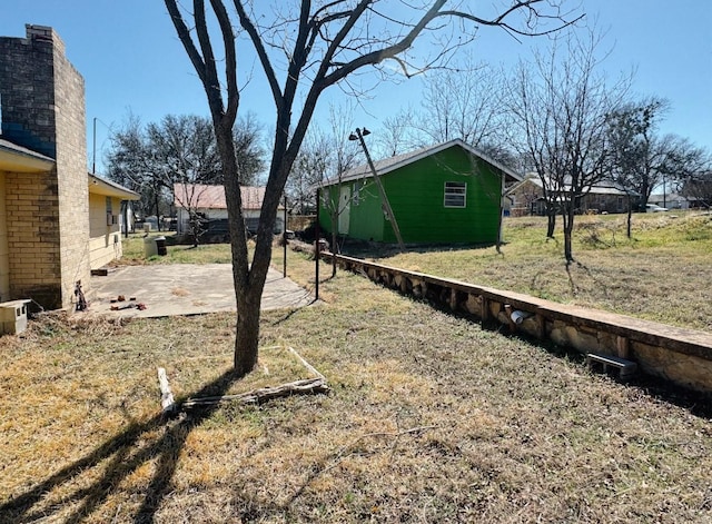 view of yard with an outdoor structure and a patio