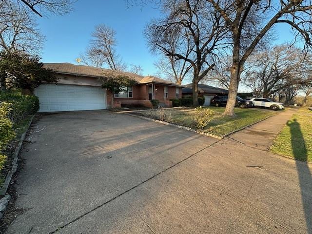 ranch-style home featuring a garage and driveway