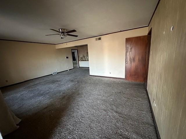 spare room featuring a ceiling fan and visible vents