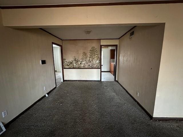 unfurnished room with baseboards and visible vents