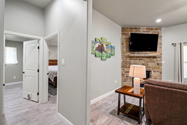 corridor with baseboards and light wood finished floors