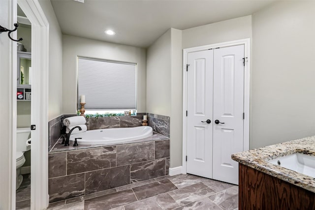 full bath with vanity, toilet, a bath, and a closet