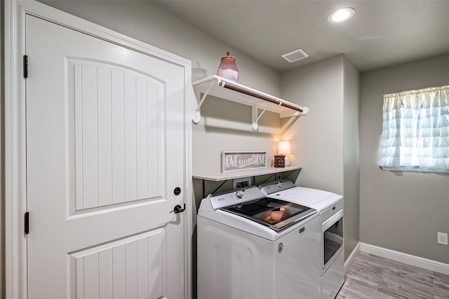 laundry area with washing machine and clothes dryer, baseboards, laundry area, recessed lighting, and light wood-style floors