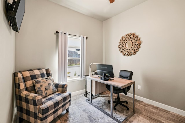 office area featuring ceiling fan, baseboards, and wood finished floors