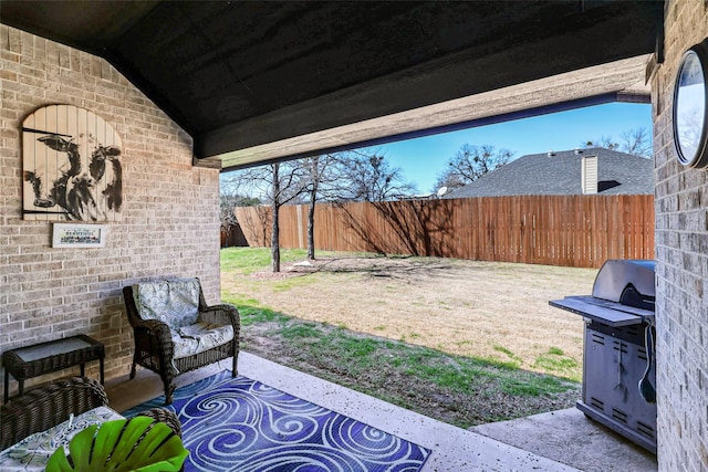 view of patio with grilling area, outdoor lounge area, and a fenced backyard