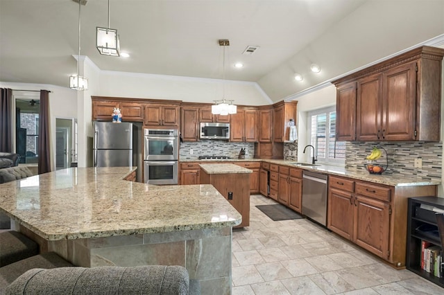 kitchen featuring visible vents, vaulted ceiling, decorative backsplash, a large island, and stainless steel appliances