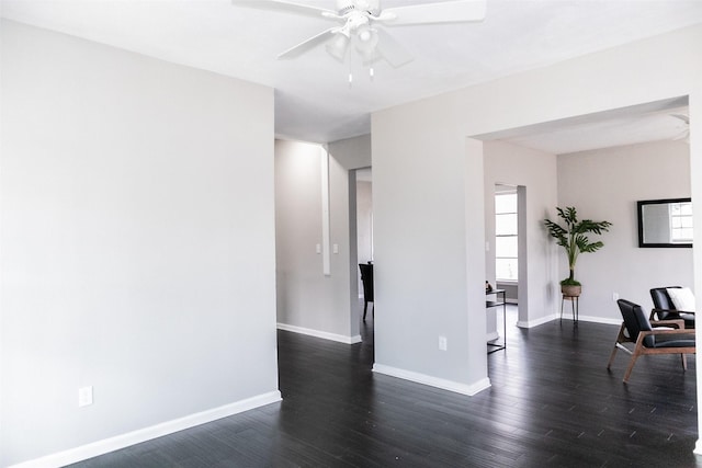 unfurnished room with ceiling fan, baseboards, and wood finished floors