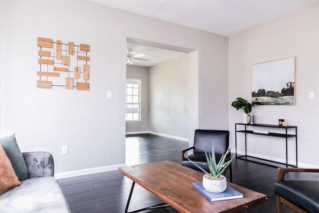 home office with ceiling fan, baseboards, and dark wood-style flooring