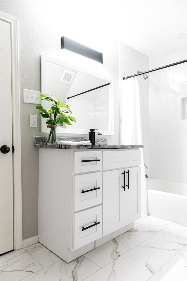 full bathroom featuring visible vents, marble finish floor, vanity, and shower / bath combo