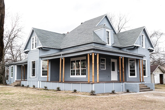 view of front of home featuring covered porch and a shingled roof