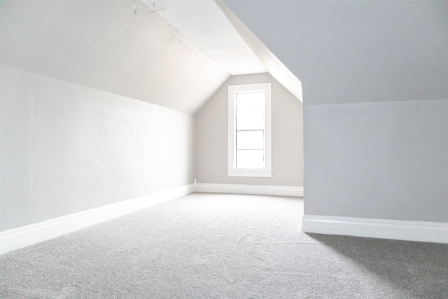 bonus room with baseboards, carpet floors, and vaulted ceiling