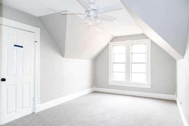 bonus room with lofted ceiling, baseboards, carpet floors, and ceiling fan