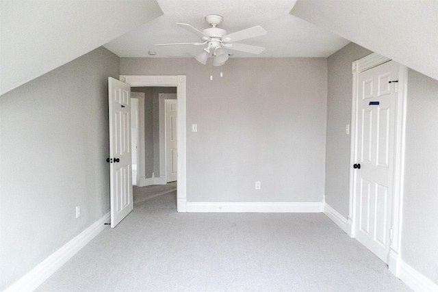 additional living space featuring baseboards, light carpet, and ceiling fan