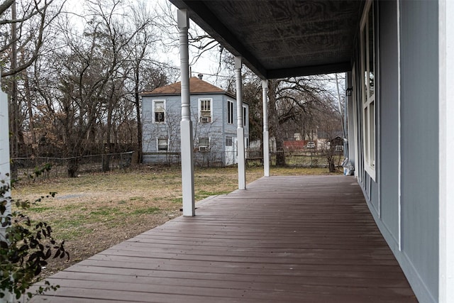 wooden terrace with a yard and fence