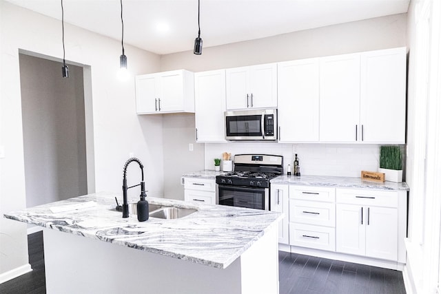 kitchen featuring white cabinetry, appliances with stainless steel finishes, and a sink