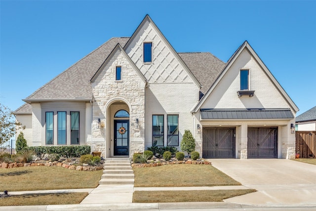 view of front facade featuring fence, a front yard, stone siding, and concrete driveway
