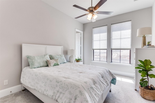 bedroom with baseboards, carpet floors, and a ceiling fan