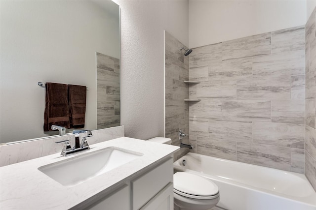 bathroom featuring bathing tub / shower combination, toilet, vanity, and a textured wall