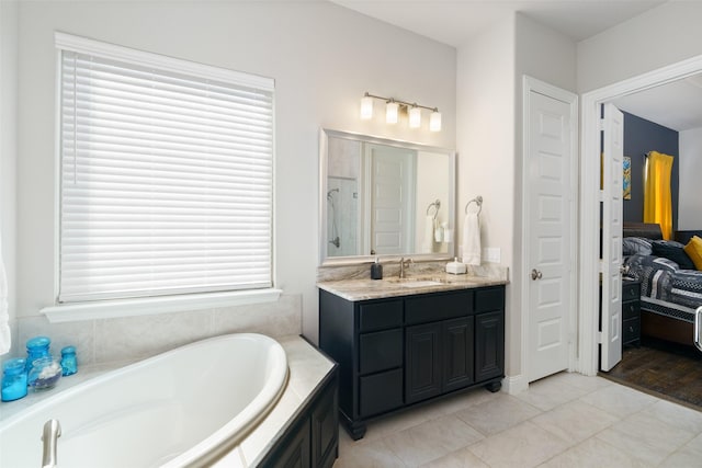 ensuite bathroom with ensuite bath, tile patterned flooring, a shower, a bath, and vanity