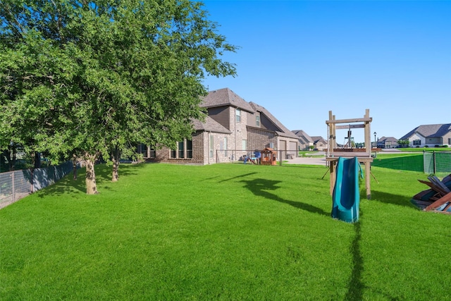 view of yard featuring a playground and fence