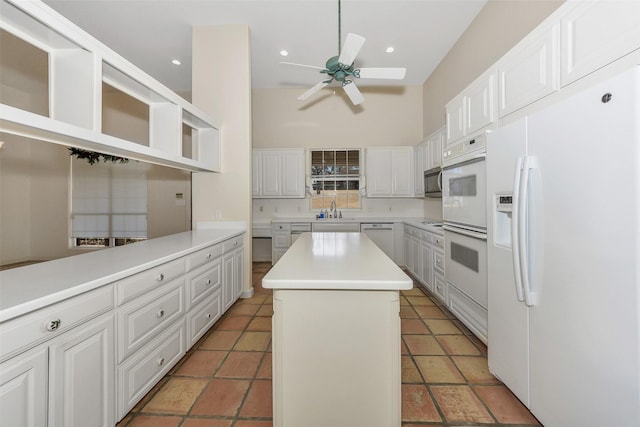 kitchen with a sink, a center island, ceiling fan, appliances with stainless steel finishes, and open shelves