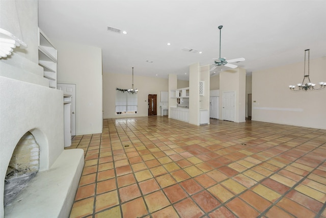 living room featuring visible vents, recessed lighting, ceiling fan with notable chandelier, a towering ceiling, and light tile patterned flooring