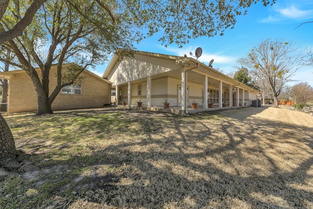 exterior space with a yard, a patio, and cooling unit